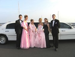 wedding party beside stretched limo