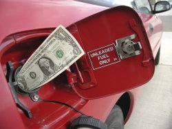 a bank note sticking out of a car fuel tank