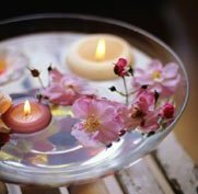 tea lights floating in a bowl of water