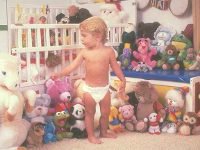 toddler sourrounded by toys