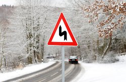 road bends traffic signal in snowy surroundings
