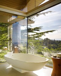freestanding bath by glass patio doors overlooking view