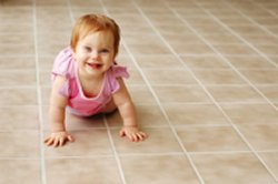 baby crawling on tiled floor