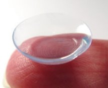 contact lens balanced on index finger