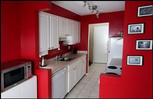 kitchen with red walls and white cabinets