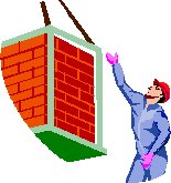 man guiding a load of bricks on a crane