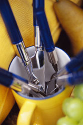 yellow mug containing utensils